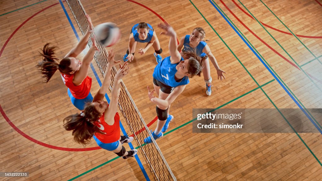 Female volleyball players playing volleyball