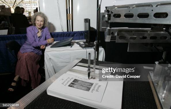 margaret-atwood-uses-her-longpen-invention-for-signing-books-remotely-for-readers-at-the-book.jpg