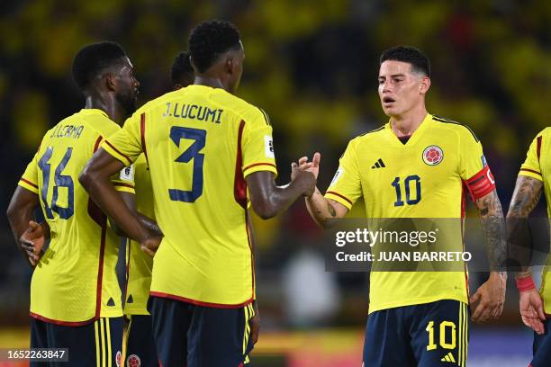 Colombia's midfielder James Rodriguez celebrates with defender Jhon Lucumi and midfielder Jefferson Lerma after defeating Venezuela at the end of the...