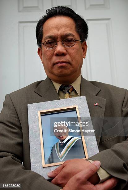 Willie Reodica holds a grade 8 graduation picture of his son, Jeffrey, who was shot by an undercover police officer last Friday.