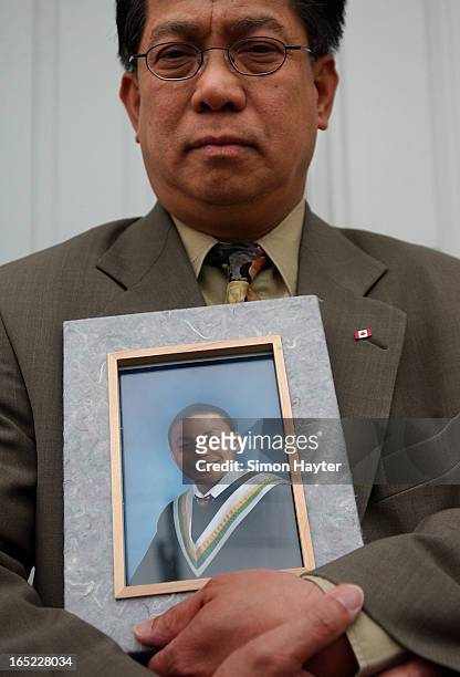Willie Reodica holds a grade 8 graduation picture of his son, Jeffrey, who was shot by an undercover police officer last Friday.