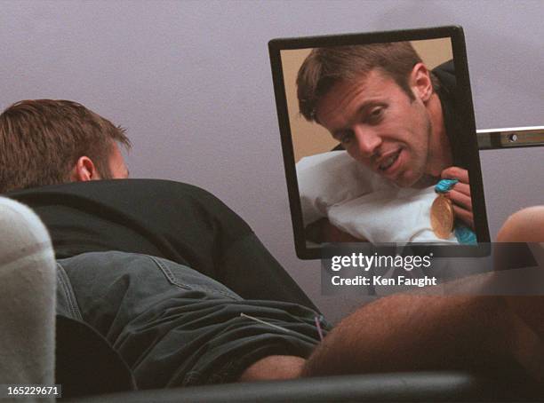 Daniel Nestor shows off his medal with some difficulty as he is receiving acupuncture treatment for achilles tendonitis at the Sports Medicine Clinic...