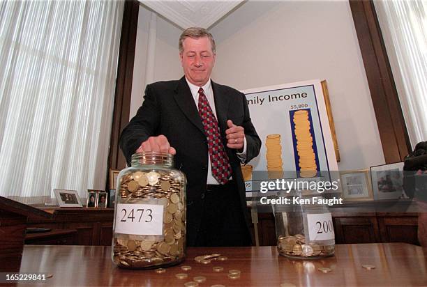 Mike Harris scoops and pours loonies to show what a .gee whiz i'm so good. Premier he has been.