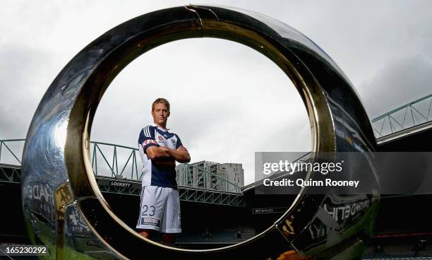 Adrian Leijer of the Victory poses with the A-League trophy during the Melbourne Victory A-League 2013 Finals Series Launch at Etihad Stadium on...