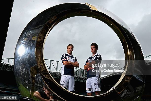 Adrian Leijer and Marcos Rojas of the Victory pose with the A-League trophy during the Melbourne Victory A-League 2013 Finals Series Launch at Etihad...