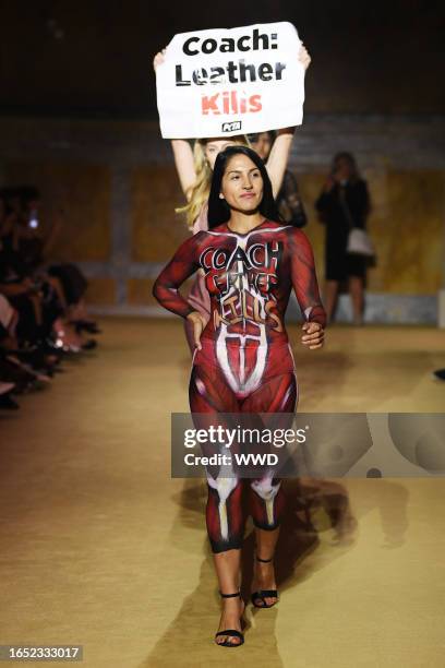 Protesters Model on the runway at the COACH Spring 2024 Ready To Wear Fashion Show and dinner event at the New York Public Library on September 7,...