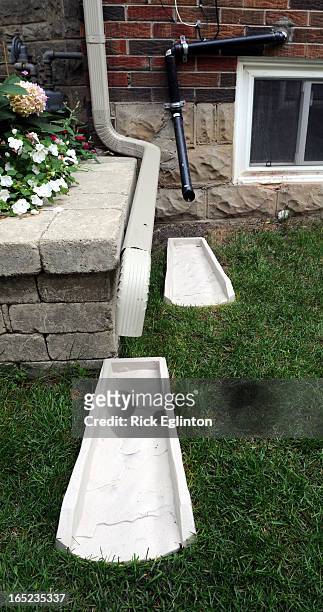 August1909RE4158375Home retrofitting to prevent basement flooding.Downspout and black pipe from sump pump run water away from house.Rick Eglinton...