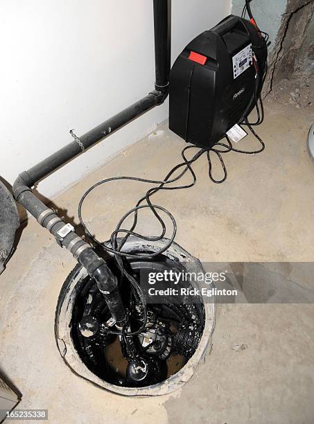 August1909RE6158375Home retrofitting to prevent basement flooding.Electric Sump Pump in basement.Rick Eglinton Toronto Star.