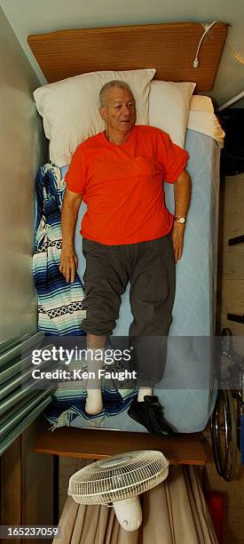 Kf_alyn_kemp_11/2/03_Phototrak090644 Alyn Kemp, partially blind, missing a foot, on his bed at Strathmere Lodge in Strathroy, Ontario. Ken...