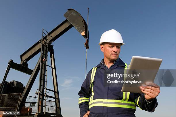 trabajador del petróleo y ordenador - oil field fotografías e imágenes de stock