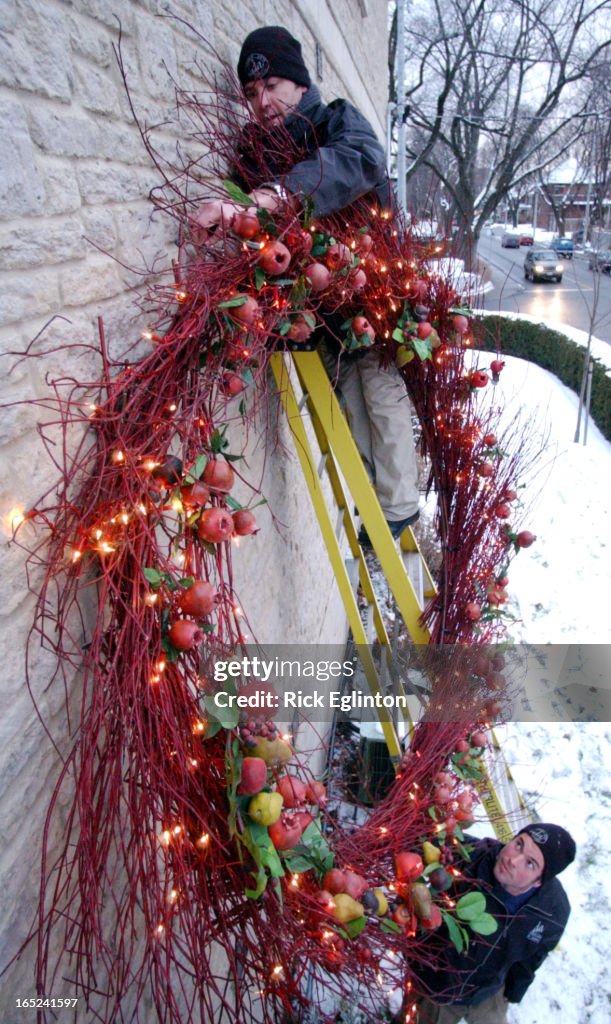 Reo1 121802 Xmas Wreath.Jason Smith from Display Arts of Toronto and his helper Rob Hodge on the gro