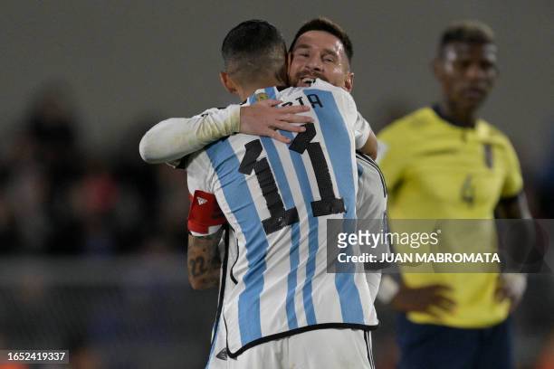 Argentina's forward Lionel Messi gives the captain's armband to teammate Angel Di Maria as he is substituted during the 2026 FIFA World Cup South...