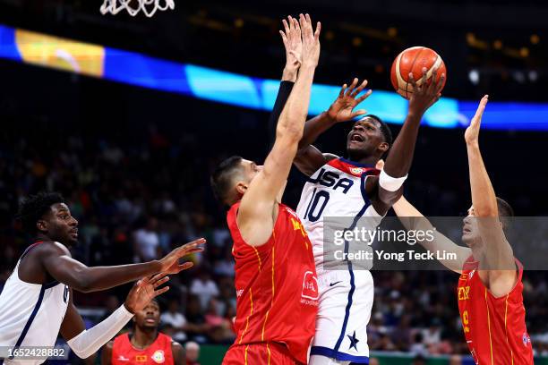 Anthony Edwards of the United States drives to the basket against Nikola Vucevic and Marko Simonovic of Montenegro in the third quarter during the...