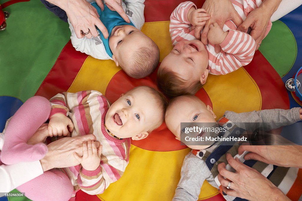 Overhead view of playing nursery babies