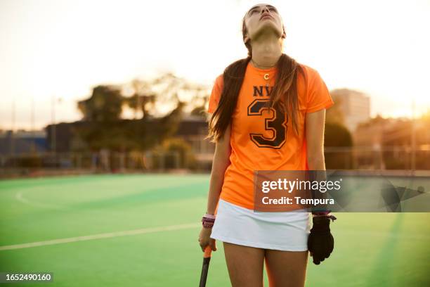 seeking solace in dusk: player's lone walk - youth sports competition stock pictures, royalty-free photos & images