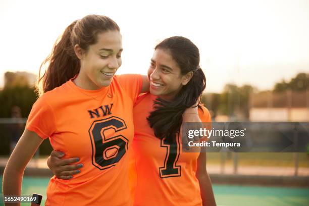 victorious duo: players leave the field in triumph. - youth sports competition stock pictures, royalty-free photos & images