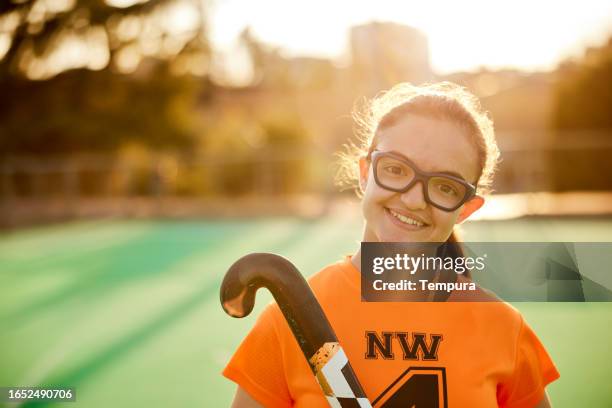 cheerful assurance: teen female hockey player's self-assured head-shot - youth sports competition stock pictures, royalty-free photos & images