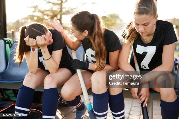 teenage hockey player: girl engaged in hockey game - youth sports competition stock pictures, royalty-free photos & images