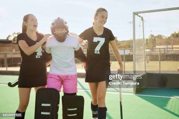 goalkeeper's triumph: teammates huddle in appreciation for save - youth sports competition stock pictures, royalty-free photos & images