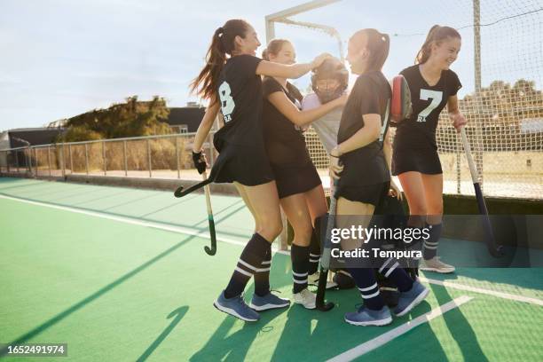 goalkeeper's save: teammates congratulate her with a bundle - youth sports competition stock pictures, royalty-free photos & images