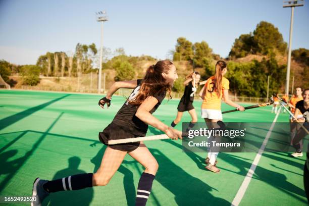 joyous sprint: teammates celebrate a goal with elation - youth sports competition stock pictures, royalty-free photos & images