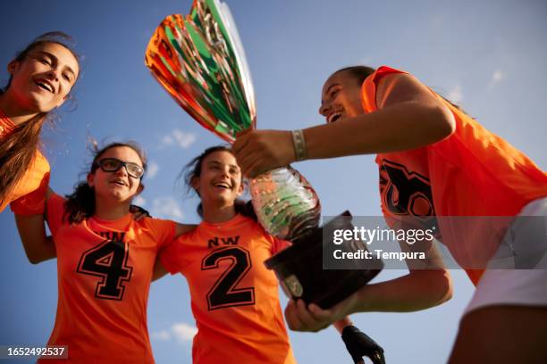 towering victory: low angle view of trophy celebration - hockey championship stock pictures, royalty-free photos & images