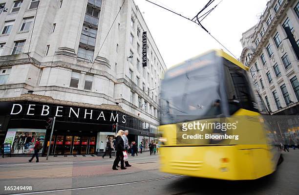 City tram passes a Debenhams Plc department store in central Manchester, U.K., on Monday, April 1, 2013. U.K. Retail sales unexpectedly stagnated in...