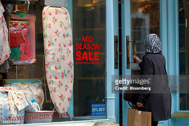 Customer enters a Cath Kidston Ltd. Store advertising a sale in Manchester, U.K., on Monday, April 1, 2013. U.K. Retail sales unexpectedly stagnated...