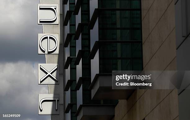 Logo hangs on display outside a Next Plc store in Manchester, U.K., on Monday, April 1, 2013. U.K. Retail sales unexpectedly stagnated in March in a...