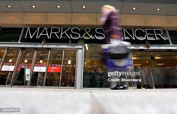 Pedestrian passes a Marks & Spencer Group Plc store in Manchester, U.K., on Monday, April 1, 2013. U.K. Retail sales unexpectedly stagnated in March...