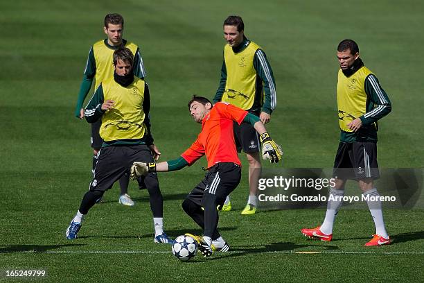 Goalkeeper Iker Casillas excersises with teammates Pepe , Gonzalo Higuain , Fabio Cohentrao and Nacho Fernandez during a training session ahead of...