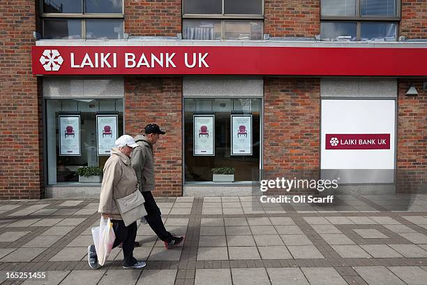 Couple walks past a branch of Laiki Bank UK, a subsiduary of Cyprus Popular Bank, on April 2, 2013 in London, England. Customers with funds in Laiki...