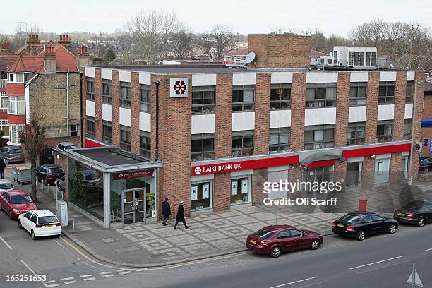 Men walk past a branch of Laiki Bank UK, a subsiduary of Cyprus Popular Bank, on April 2, 2013 in London, England. Customers with funds in Laiki Bank...
