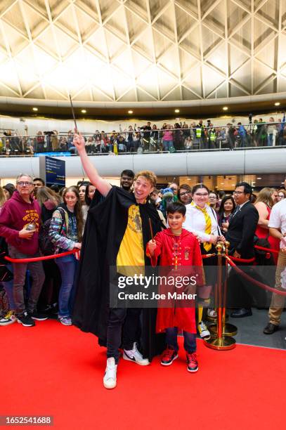 Sam Thompson and competition winner Arnav during Back To Hogwarts Day 2023 at King's Cross station on at King's Cross station on September 01, 2023...