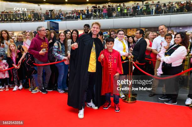 Sam Thompson and competition winner Arnav =during Back To Hogwarts Day 2023 at King's Cross station on at King's Cross station on September 01, 2023...