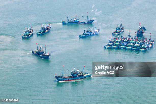 Aerial view of fishing boats setting sail from Jimiya port as the summer fishing ban ended in the Yellow and Bohai seas on September 1, 2023 in...