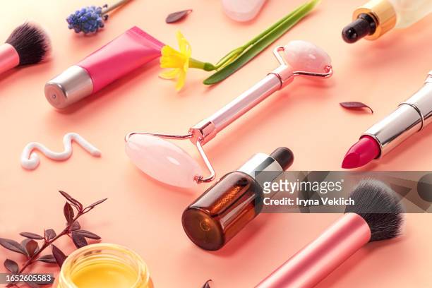 collection  of beauty cosmetic products and flowers of orchid and daffodil on pastel pink background. - fuchsia orchids stock pictures, royalty-free photos & images