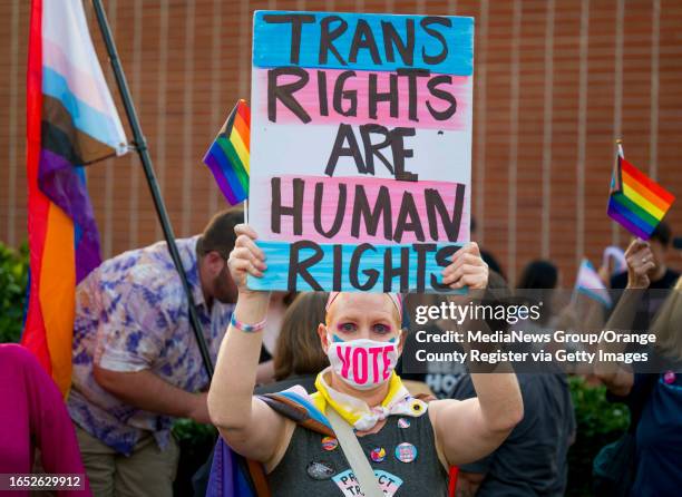 Micki Simon, a teacher in Santa Ana and a parent of transgender child protests against the transgender notification policy outside the Orange Unified...