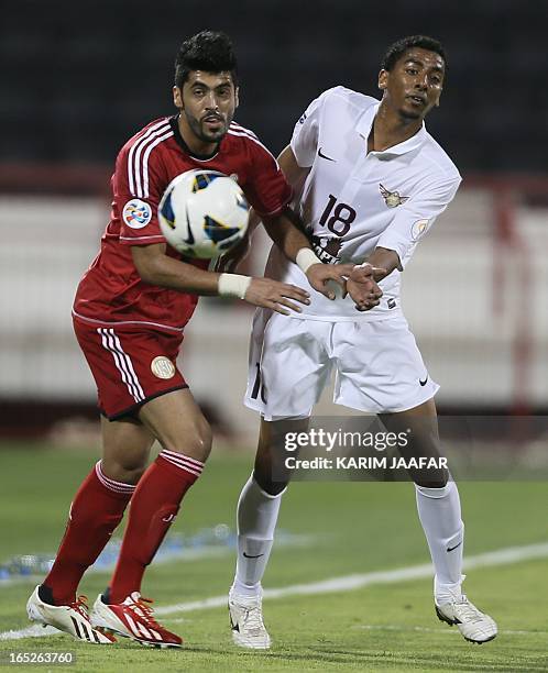 Qatar's al-Jaish player Mohammed El-Sayed Jedo challenges Abdulla Mousa of UAE's Al-Jazira club during their AFC Champions League soccer match in...