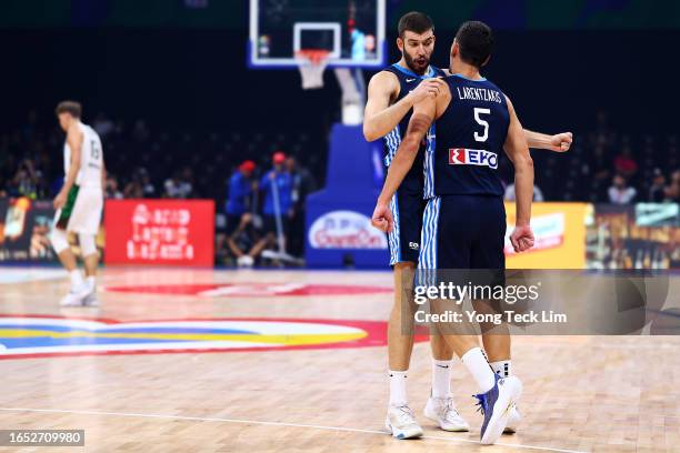 Giannoulis Larentzakis of Greece celebrates with Nikos Rogkavopoulos after scoring off a fast break to force a timeout in the second quarter during...