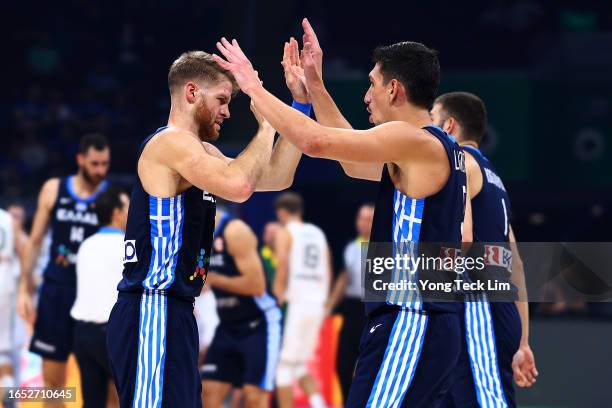 Giannoulis Larentzakis of Greece celebrates with Thomas Walkup after scoring off a fast break to force a timeout in the second quarter during the...