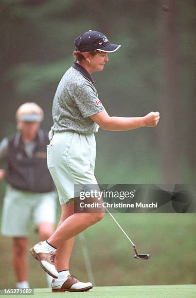 Eathorne contemplates her putt while team-mate Lorie Kane keeps her dry as well as collaborates on the shot. Canadian Gail Graham digs herself out of...