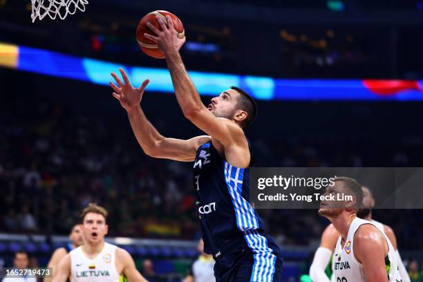 Ioannis Papapetrou of Greece drives to the basket against Eimantas Bendzius of Lithuania in the second quarter during the FIBA Basketball World Cup...