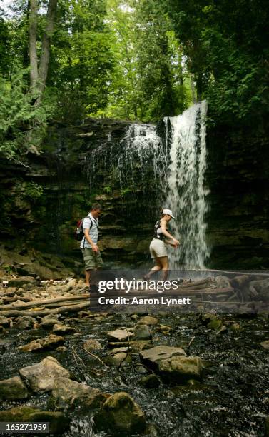 Owen Shaw and Julija Ezergailis hike past Hilton Falls, a picturesque waterfalls that runs down the Niagara Escarpment, at Hilton Falls conservation...