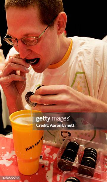 Professional competitive eater Tom 'Goose' Gilbert inhales cream filled cookies at the second annual 'Eat Your Face Off' competitive eating...