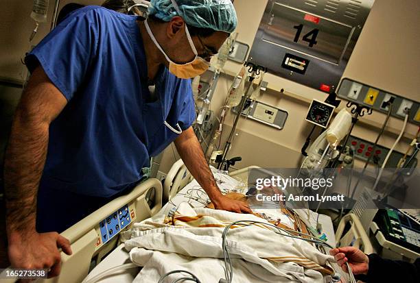 Cardiac surgeon Dr. Subdoh Verma checks up on his patient Ashok Verma in the intensive care unit in the minutes following his triple bypass cardiac...