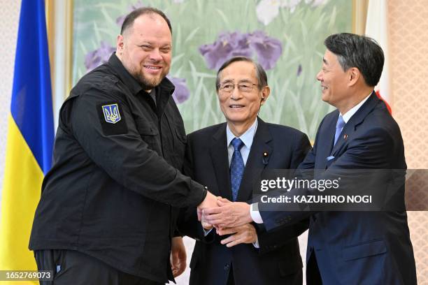 This photo taken on September 7, 2023 shows Hiroyuki Hosoda , the Speaker of the House of Representatives of Japan, shaking hands with Chairman of...