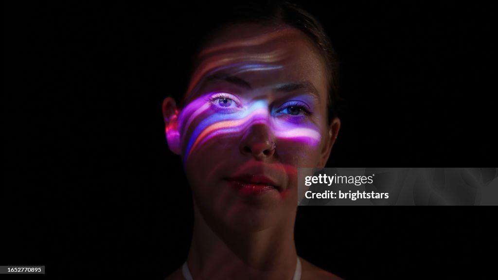 Neon lights on a woman's face