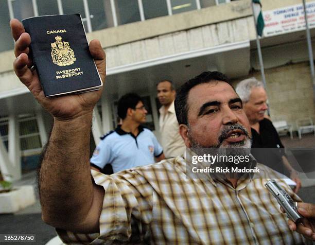 Evacuation - 07/21/06 - MERSIN, TURKEY - Sami Dia, of Ottawa, holds up his passport and speaks about Canada's help in getting out of Lebannon. He is...