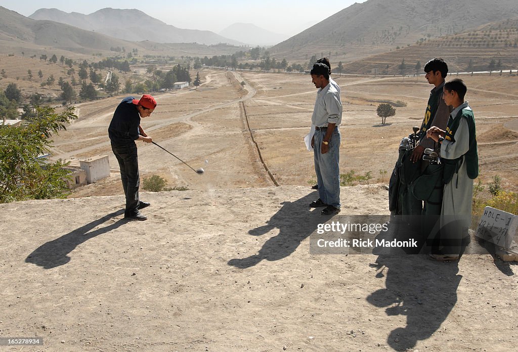 Golf - 10/04/06 - KABUL, AFGHANISTAN - Naween, 18, hits from the tee box of the 1st hole, a 371 yard